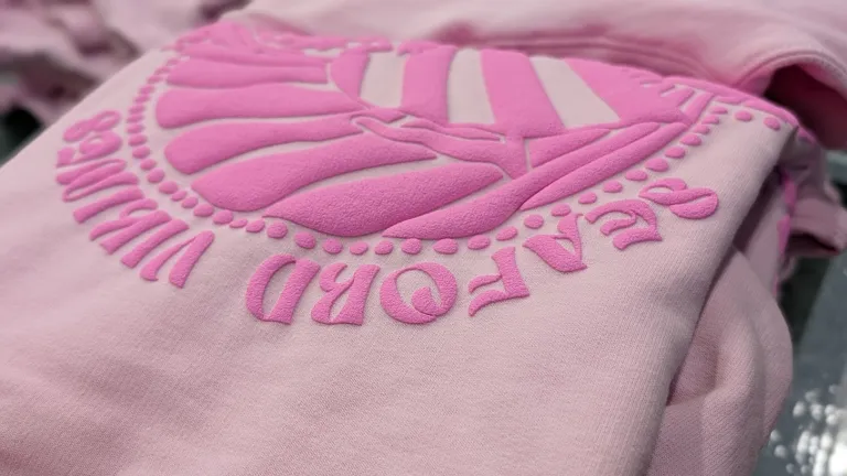 Detailed close-up of pink puff print “Seaford Vikings” logo on a sweatshirt showing raised ink texture and dimensional print quality from AMBRO Manufacturing.