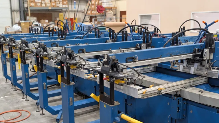 Screen printing press printing custom shirts in New Jersey facility