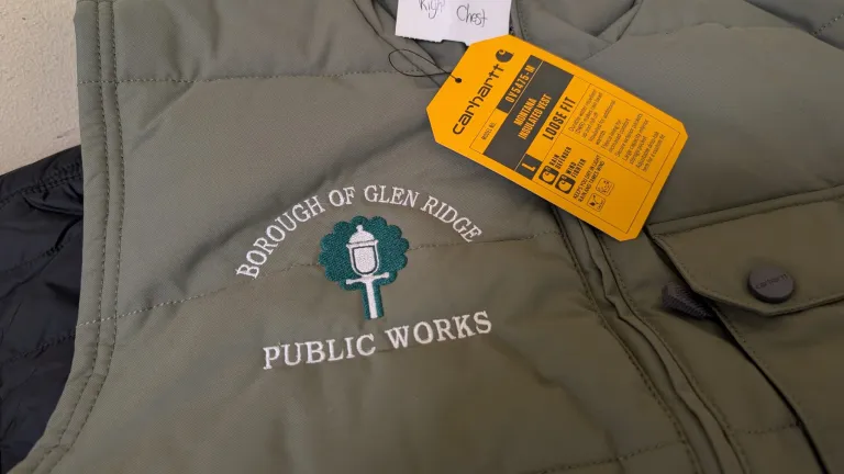 Carhartt insulated vest with an embroidered Borough of Glen Ridge Public Works logo and attached product tag.