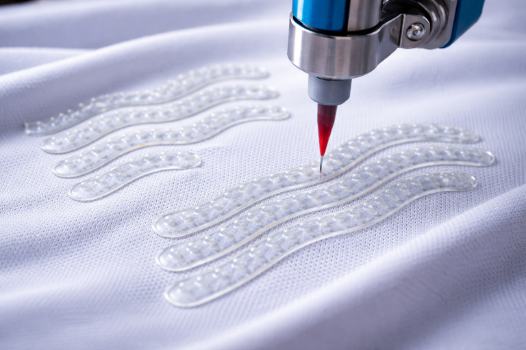 Silicone non-slip gripper patterns printed on medical fabric for wearable medical device stability