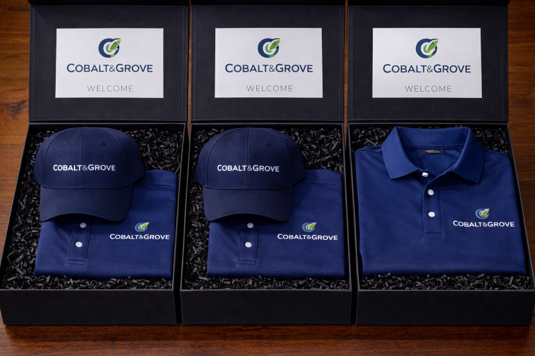 VIP welcome kit boxes with Cobalt & Grove embroidered polo shirt and embroidered baseball cap